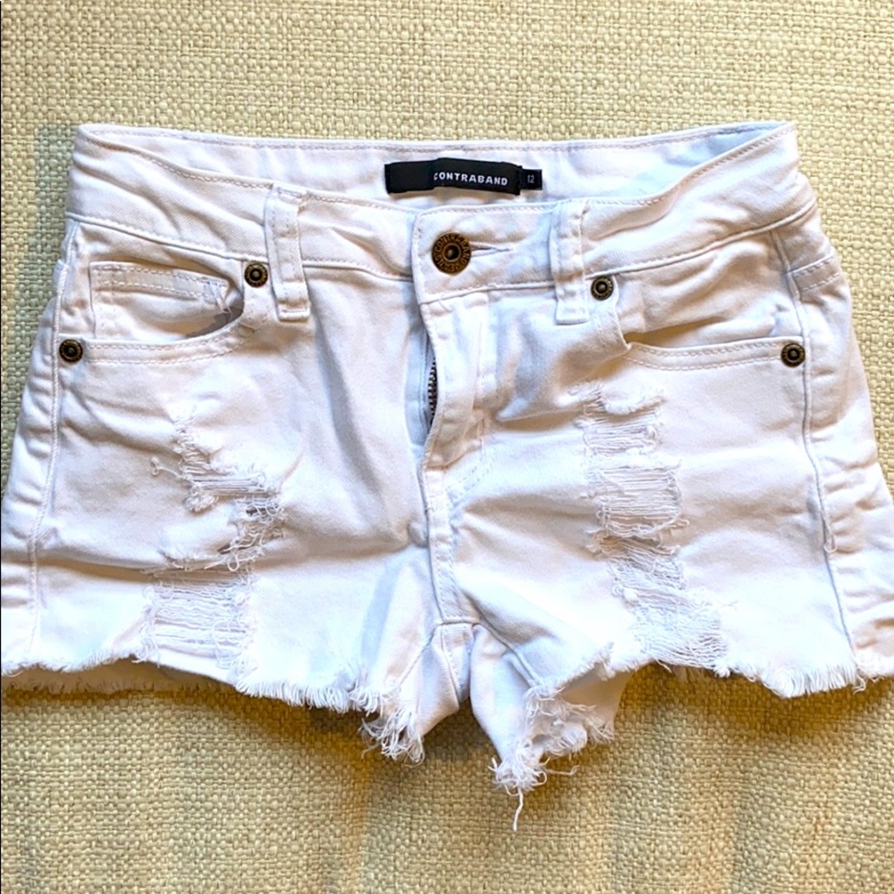 Contraband white distressed shorts.